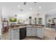 Spacious kitchen and Gathering room featuring light cabinetry, solid surface countertops, and backyard view at 23510 Oak Prairie Cir, Sorrento, FL 32776