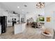 Open-concept kitchen and living area with white cabinetry, stainless appliances, and modern fixtures at 23510 Oak Prairie Cir, Sorrento, FL 32776