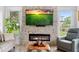Bright living room features a stone fireplace, recessed lighting, neutral walls, and wood look flooring at 23510 Oak Prairie Cir, Sorrento, FL 32776