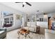 Bright living room showcases an open floorplan with wood-look flooring and neutral walls at 23510 Oak Prairie Cir, Sorrento, FL 32776