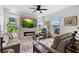 Bright living room features a stone fireplace, recessed lighting, neutral walls, and wood look flooring at 23510 Oak Prairie Cir, Sorrento, FL 32776
