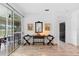 Elegant sitting area with wood-look tile flooring, sliding glass doors to lanai, and decorative furnishings at 23510 Oak Prairie Cir, Sorrento, FL 32776