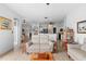 Bright living room showcases an open floorplan with wood-look flooring and white neutral walls at 23510 Oak Prairie Cir, Sorrento, FL 32776