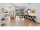 Bright, open floor plan with wood-look tile flooring, modern lighting, and view to the backyard patio at 23510 Oak Prairie Cir, Sorrento, FL 32776