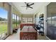 Covered patio with a hot tub, ceiling fan, wood-look tile floor, and an outdoor dining table at 23510 Oak Prairie Cir, Sorrento, FL 32776