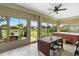Screened-in porch with a dining table and hot tub at 23510 Oak Prairie Cir, Sorrento, FL 32776