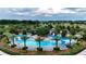 Aerial view of a beautiful community pool, surrounded by Palm trees and greenery at 5237 Nw 48Th Pl, Ocala, FL 34482