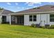 Spacious backyard featuring lush green lawn, screened-in patio, and manicured landscaping at 5237 Nw 48Th Pl, Ocala, FL 34482