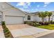 Charming home featuring a neutral exterior, paver driveway, stone accents and fresh landscaping at 5237 Nw 48Th Pl, Ocala, FL 34482