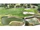 Aerial view of golf course pond with sand traps and bridges, with trees in Ocala Preserve at 5237 Nw 48Th Pl, Ocala, FL 34482