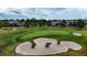 A beautiful shot of a golf course, with sand traps and surrounding homes at 5237 Nw 48Th Pl, Ocala, FL 34482