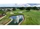 Aerial view of golf course pond and green with sand traps in Ocala Preserve at 5237 Nw 48Th Pl, Ocala, FL 34482