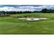 Golf course with a sand trap surrounding the green in the Ocala Preserve community at 5237 Nw 48Th Pl, Ocala, FL 34482