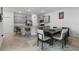 Open kitchen features gray cabinets, stainless steel appliances, and dining area at 5237 Nw 48Th Pl, Ocala, FL 34482