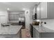 Bright kitchen features gray cabinetry, stainless steel appliances, and granite counters with white subway tile backsplash at 5237 Nw 48Th Pl, Ocala, FL 34482