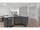 This kitchen features a gray island with sink, granite countertops, and stainless steel appliances at 5237 Nw 48Th Pl, Ocala, FL 34482