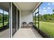 Relaxing screened lanai with chairs offers peaceful outdoor living space with nature views at 5237 Nw 48Th Pl, Ocala, FL 34482