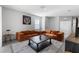 Open living room with tile flooring and an oversized comfy couch at 5237 Nw 48Th Pl, Ocala, FL 34482