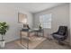 Modern home office with large window, stylish desk, and comfortable seating area for a productive workspace at 5237 Nw 48Th Pl, Ocala, FL 34482