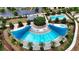 Aerial view of a large community pool, surrounded by lounge chairs and palm trees at 5237 Nw 48Th Pl, Ocala, FL 34482