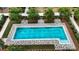 Aerial view of a pool with marked lap lanes and lounge chairs on a sunny day at 5237 Nw 48Th Pl, Ocala, FL 34482