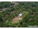 Aerial image showing property boundaries with a house surrounded by dense trees, creating a private and natural setting at 3005 Se 156Th Place Rd, Summerfield, FL 34491