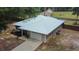Aerial view of home with a newly installed metal roof and attached garage at 3005 Se 156Th Place Rd, Summerfield, FL 34491