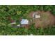 Bird's eye view of a metal roof house with garage on wooded lot at 3005 Se 156Th Place Rd, Summerfield, FL 34491