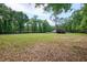Spacious backyard with a covered structure set among mature trees at 3005 Se 156Th Place Rd, Summerfield, FL 34491