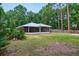 Beautiful backyard featuring a screened-in porch, and a basketball hoop at 3005 Se 156Th Place Rd, Summerfield, FL 34491