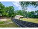 Large, grassy backyard featuring a barn, surrounded by wooden fence at 3005 Se 156Th Place Rd, Summerfield, FL 34491