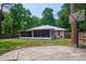 A large backyard with a screened porch, and a basketball hoop at 3005 Se 156Th Place Rd, Summerfield, FL 34491