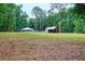 Expansive backyard featuring a covered structure and well-maintained lawn at 3005 Se 156Th Place Rd, Summerfield, FL 34491