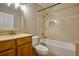 The bathroom features a vanity, toilet, and a bathtub with tiled walls and shower-head fixture at 3005 Se 156Th Place Rd, Summerfield, FL 34491