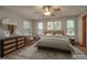 Staged bedroom featuring neutral walls and wood-look floors at 3005 Se 156Th Place Rd, Summerfield, FL 34491