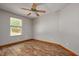 An empty bedroom featuring wood floors, neutral walls, a ceiling fan and one window at 3005 Se 156Th Place Rd, Summerfield, FL 34491