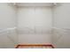 Spacious walk-in closet with bright white shelves and neutral walls, ready to be organized at 3005 Se 156Th Place Rd, Summerfield, FL 34491
