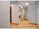 Hallway features neutral paint, tiled flooring and mirrored closet doors at 3005 Se 156Th Place Rd, Summerfield, FL 34491