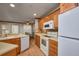 Kitchen featuring tile floors, oak cabinets, white appliances and a breakfast area with a ceiling fan at 3005 Se 156Th Place Rd, Summerfield, FL 34491