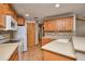 Traditional kitchen with wooden cabinets, light countertops, and stainless steel appliances at 3005 Se 156Th Place Rd, Summerfield, FL 34491