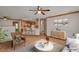 Staged living room with neutral walls, tile flooring, furnishings and kitchen at 3005 Se 156Th Place Rd, Summerfield, FL 34491
