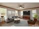 Staged living room with neutral walls, tile flooring, and furnishings at 3005 Se 156Th Place Rd, Summerfield, FL 34491