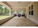Spacious screened porch with wicker furniture and outdoor views at 3005 Se 156Th Place Rd, Summerfield, FL 34491