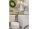 Bathroom features a modern vanity, decorative mirror and light fixture, and a step-in shower at 1157 Hollow Pine Dr, Oviedo, FL 32765