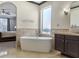 Elegant bathroom with a free-standing tub, vanity, and a view into the main bedroom at 1157 Hollow Pine Dr, Oviedo, FL 32765