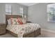 Inviting bedroom features a floral-patterned bed with storage drawers and neutral decor, offering a relaxing retreat at 1157 Hollow Pine Dr, Oviedo, FL 32765