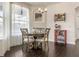 Bright dining area features a round table, chairs, elegant chandelier, and a built-in wine rack at 1157 Hollow Pine Dr, Oviedo, FL 32765
