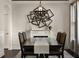 Elegant dining room featuring a decorative light fixture and a dark wood table set with upholstered chairs at 1157 Hollow Pine Dr, Oviedo, FL 32765