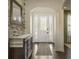 Inviting foyer with a decorative stone wall, dark wood floors, and a stylish front door with sidelights at 1157 Hollow Pine Dr, Oviedo, FL 32765