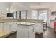 Open-concept kitchen with granite countertops, a center island, and a dining area with natural light at 1157 Hollow Pine Dr, Oviedo, FL 32765